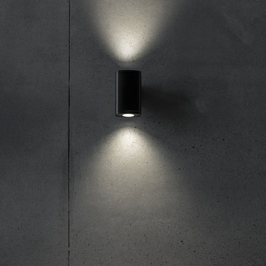 Twin GU10 facade wall light illuminated on a wall