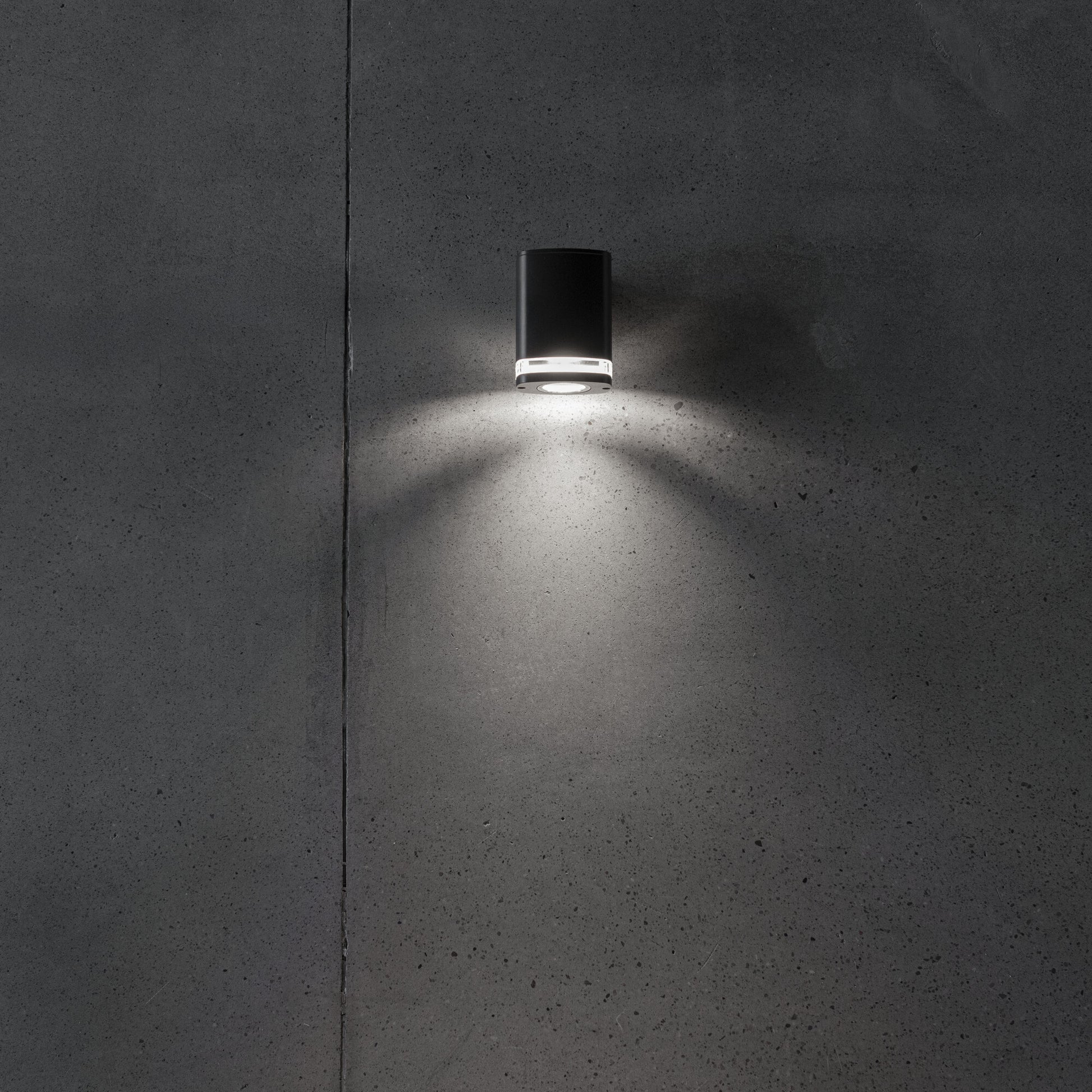 Wide GU10 facade wall light illuminated on a wall