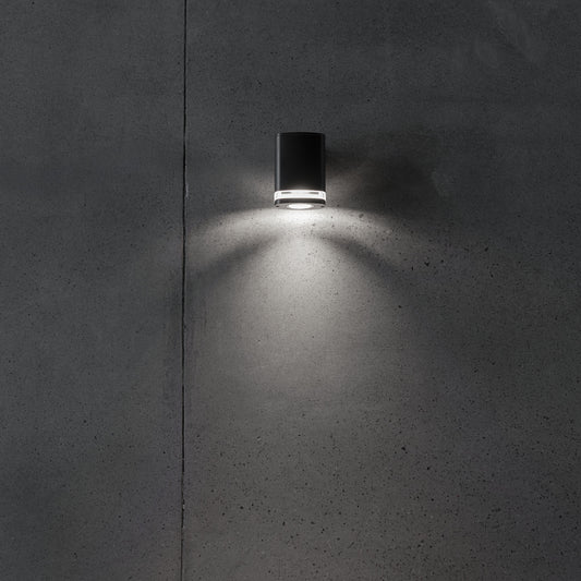 Wide GU10 facade wall light illuminated on a wall