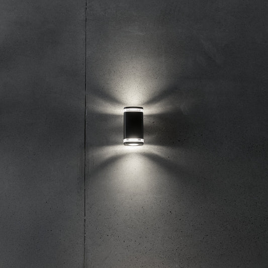 Wide twin GU10 facade wall light illuminated on a wall